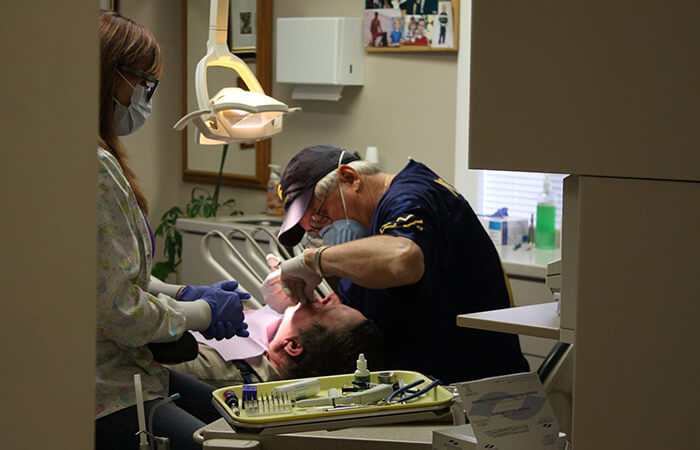 Dr. Payne working on male patient's teeth