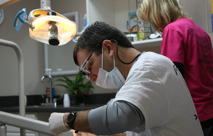 Dr. Payne volunteering dental work on a patient