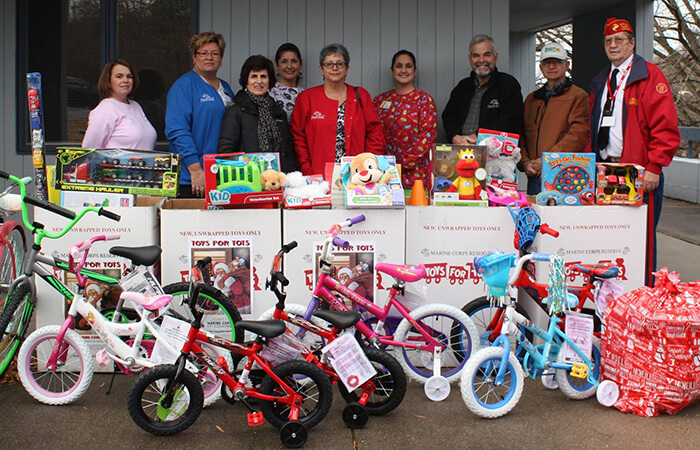 Dr. Albert Payne and his Toys for Tots crew taking a photo with their donations